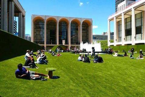 People enjoying a spring day on grass installation at Lincoln Center - Image by Joe Tabacca